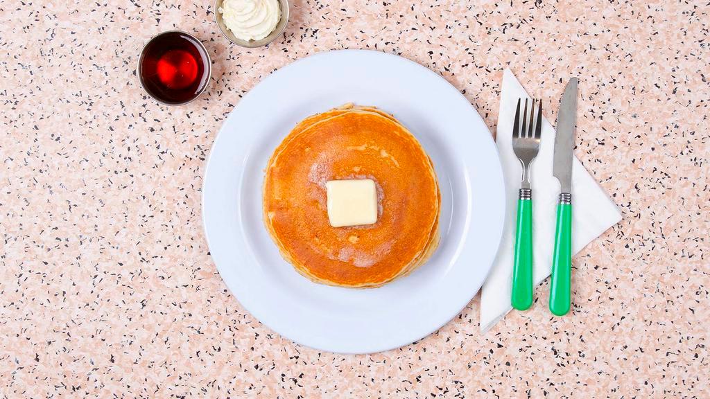 Pancakes · Three fluffy pancakes with maple syrup and butter.