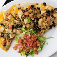 Grilled Chicken Quesadilla · Our carb-friendly quesadilla is served open-faced with blended cheeses, our house made black...