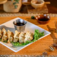 Gyoza · Fried dumplings filled with chicken and vegetables. Served with a ginger-citrus-soy dipping ...