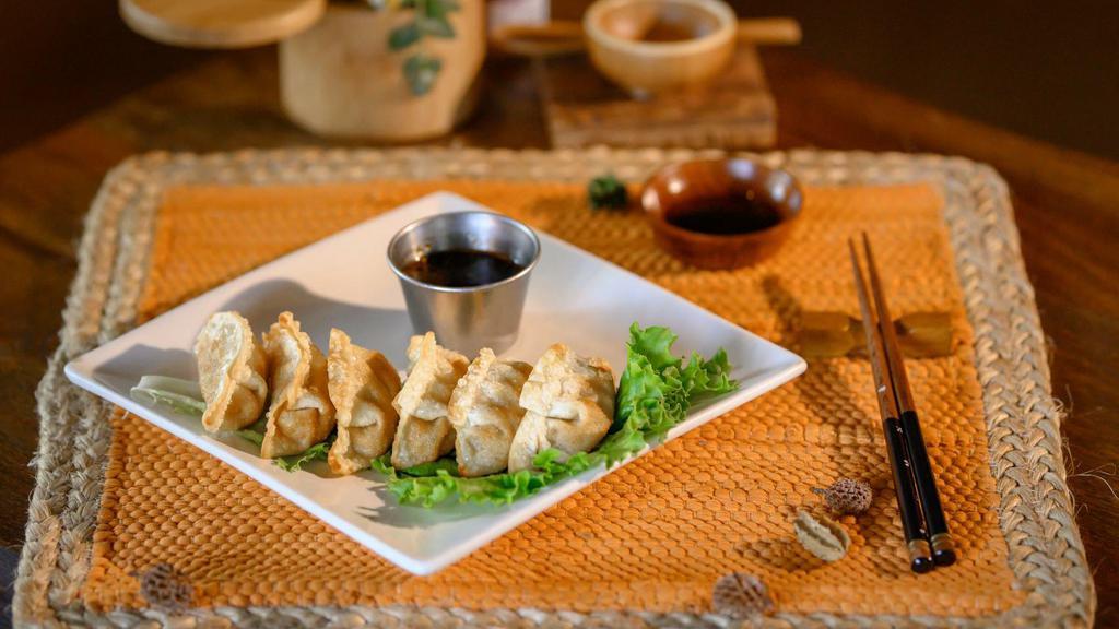 Gyoza · Fried dumplings filled with chicken and vegetables. Served with a ginger-citrus-soy dipping sauce.