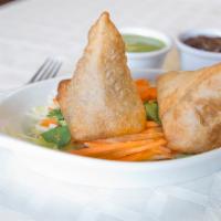 Vegetable Samosas (2 Pieces) · Crisp turnover stuffed with mildly spiced potatoes and peas.