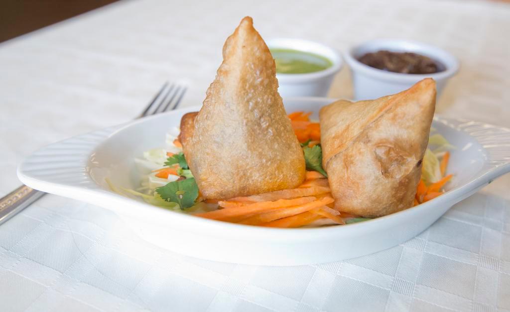 Vegetable Samosas (2 Pieces) · Crisp turnover stuffed with mildly spiced potatoes and peas.