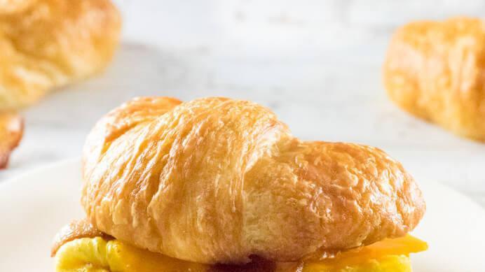 Croissant Sandwich · Scrambled eggs topped with your choice of ham, bacon, chorizo or sausage and your choice of cheese.