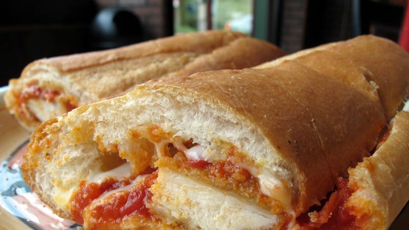 Italian Breaded Chicken · Five oz. breaded chicken breast and homemade marinara sauce, topped with melted provolone cheese, stuffed and baked in our Italian sub roll, finished with fresh oregano and parmesan. COMBO COMES WITH YOU CHOICE ,POTATO SALAD,CIPS,MAC SALAD