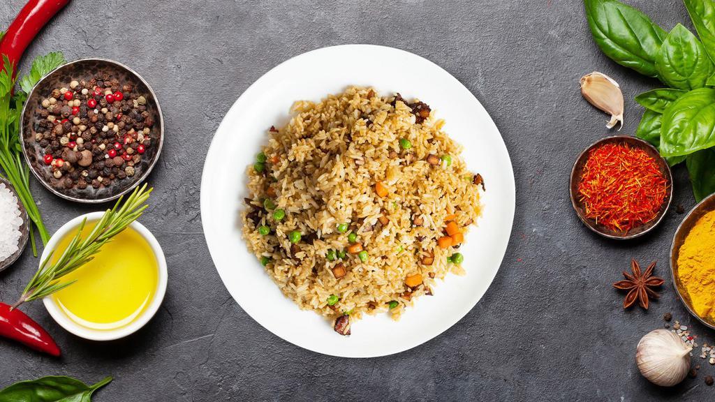 Bbq Pork Fried Rice · Stir-fried rice with sliced Chinese BBQ pork, egg, carrots, peas, onions, and collard greens. Topped with cilantro, green onions, and black pepper.