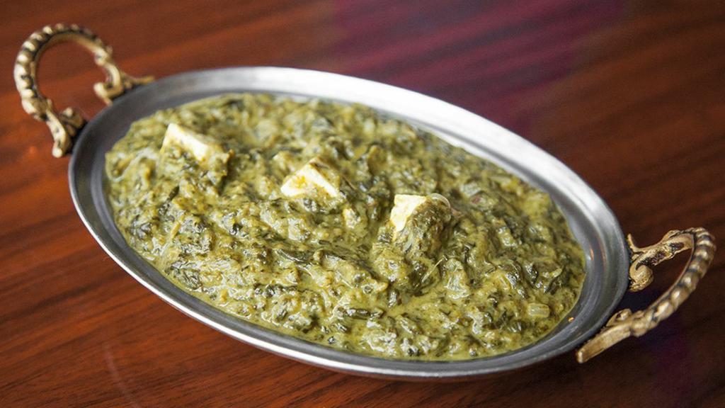 Palak Paneer/Palak Aloo · Specialty of punjab, fresh spinach cooked curry style with cheese cubes or potatoes and seasoned with aromatic herbs