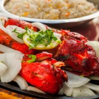 Chicken Tandoori · One half chicken marinated overnight in yogurt and very mild spices and barbecued in clay ov...