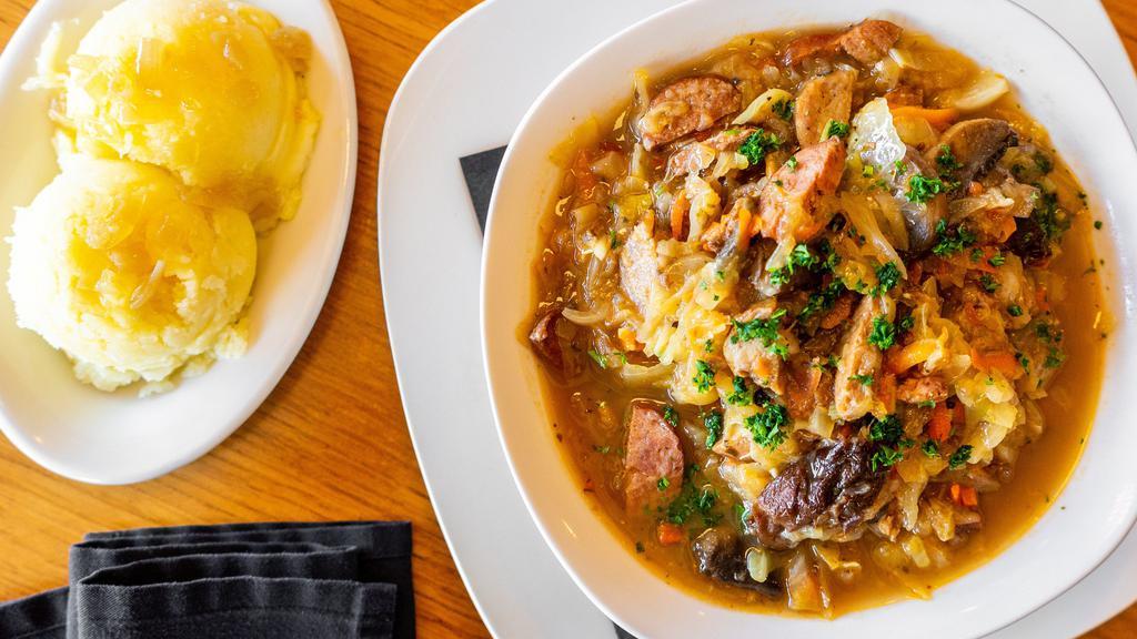 Bigos · Polish hunter stew, a savory blend of sauerkraut, sweet cabbage, slow cooked pork, mushrooms, and smoked kielbasa. Comes with your choice of bread or mashed potatoes