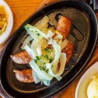 Smoked Kielbasa · Grilled polish smoked sausage, made in house, served on a hot skillet, topped with carameliz...