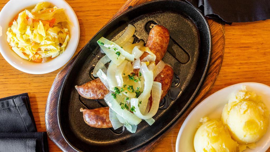 Smoked Kielbasa · Grilled polish smoked sausage, made in house, served on a hot skillet, topped with caramelized onions. Served with your choice of sauerkraut or sweet Cabbage, a side of pickles and Lester's sweet and spicy mustard