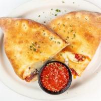 Veggie Deluxe Calzone · Black olives, Roma tomatoes, mushrooms, peppers, and red onions.