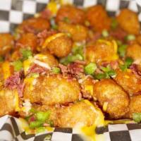 Loaded Tots · Crispy tater tots with melted cheese, bacon, chopped jalapeños and our famous mixer hot sauce.