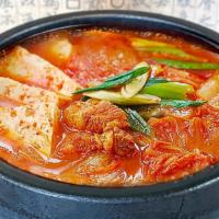 김치찌개｜Kimchi Stew · Spicy. Spicy kimchi stew with pork belly, rice cake, and tofu.