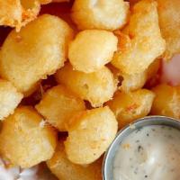 Wisconsin Cheese Curds · White cheddar cheese, tempura batter, and jalapeño ranch.