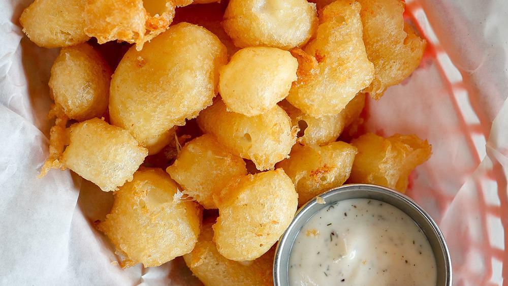 Wisconsin Cheese Curds · White cheddar cheese, tempura batter, and jalapeño ranch.