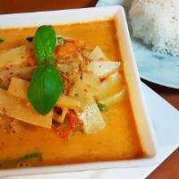Red Curry · Red chili paste curry in coconut milk with bamboo shoots, bell peppers, and Thai basil.