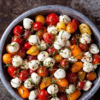 Tri Color Tomato Mozzarella Salad · Store Made Mozzarella, Tomatoes, Garlic, Garden Fresh Basil & Extra Virgin Olive Oil.