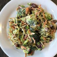 Broccoli Crunch Salad · Broccoli, Carrots, Red Onion, Raisins, Dried Cranberries, Sunflower Seeds & Dressing.