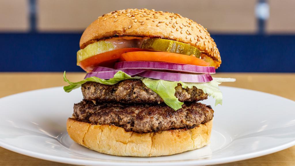 Double Burger · Two 1/3LB Hand-Made Lean USDA Beef, crisp lettuce, red ripe tomato slice, sliced red onions, hand-cut pickles and our Special Homemade sauce. Served on a toasted fresh baked sesame seed bun.