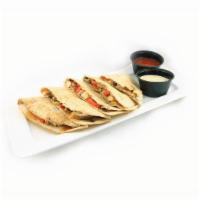 Baja Quesadilla · Grilled chicken, red and yellow peppers, black bean corn salsa & cheddar.