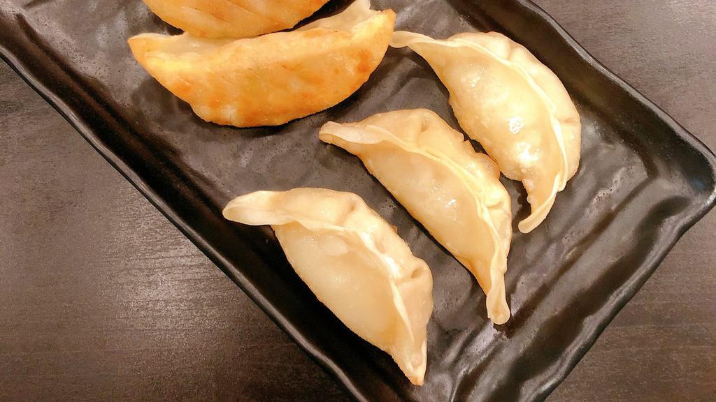 Pan Fried Pork Dumplings (6 Pieces) / 煎饺 · Serving of 6, served with a side of house-made dumpling sauce.