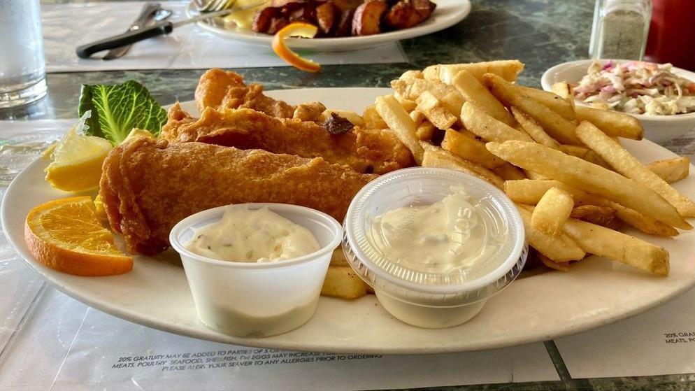 Fish N Chips · Beer battered cod fried to perfection served with coleslaw, lemon and tartar sauce.
