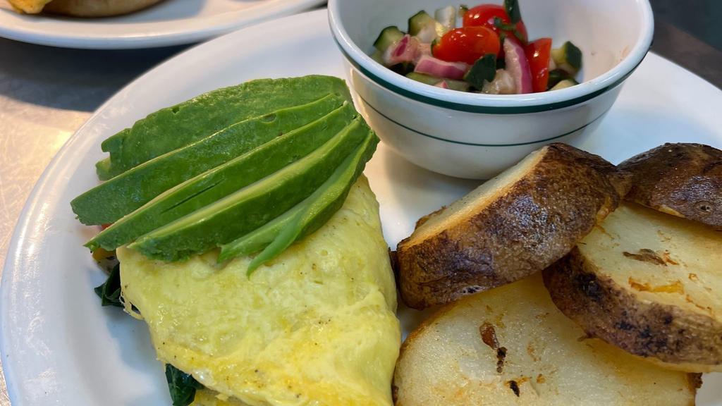Omelet · Plant-based egg omelet, Just Egg, sauteed spinach, onions, bell pepper, plant based cheddar, tomatoes, avocado. Served with tivoli salad & Potato Medallions.