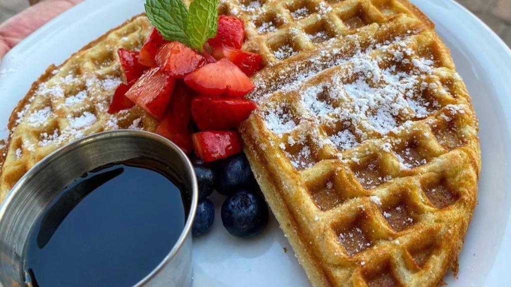 Waffles · Gluten free waffles with the choice of blueberry, strawberry, banana, or chocolate chips served with a side of maple syrup