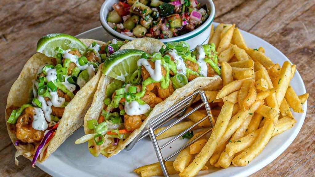 Pan Fried Cauliflower Tacos · Two vegan pan fried cauliflower tacos with cabbage shreds, tomato, cilantro, jalapeno, onion, vegan ranch, and drizzled with balsamic glaze and tapatio. Served with tivoli salad and side of fries.