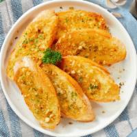 Garlic Bread · Housemade bread toasted and garnished with butter, butter, garlic, parsley and marinara sauce.