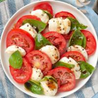 Caprese Salad · Fresh mozzarella, fresh basil, tomatoes, and virgin olive oil tossed with balsamic reduction.