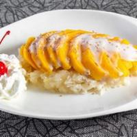 Mango Sticky Rice · coconut milk with mango slices on top over the sticky rice.