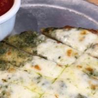 Pesto  Sticks · House-made flatbread covered with our pesto and Mozzarella. Cut into strips and served with ...