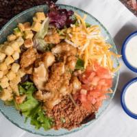 Crispy Caramel Chicken Salad · Mixed greens topped with crispy fried caramel chicken, tomato, bacon shredded cheese, and cr...