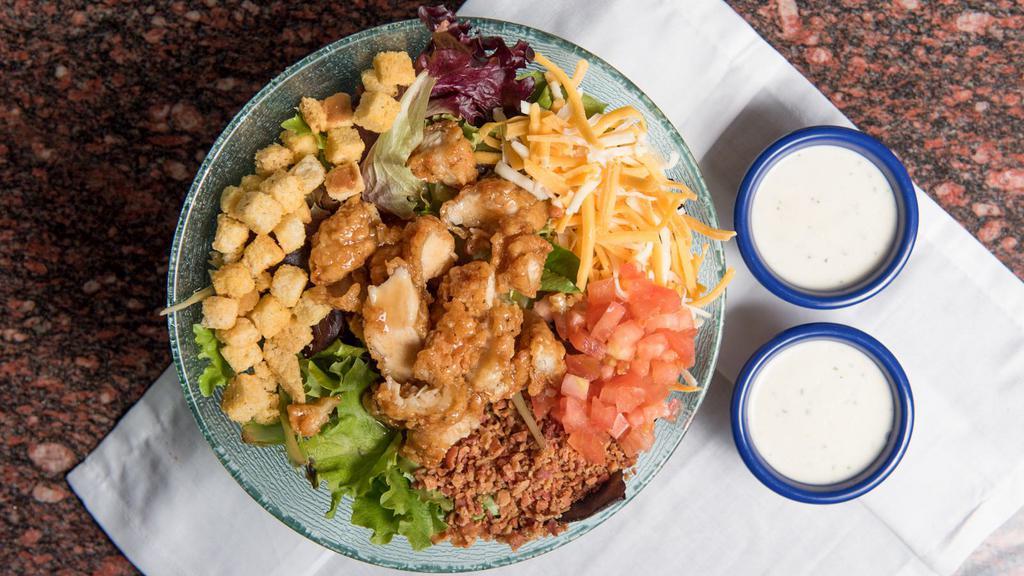 Crispy Caramel Chicken Salad · Mixed greens topped with crispy fried caramel chicken, tomato, bacon shredded cheese, and croutons tossed with ranch dressing. 1165 calories.
