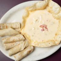 Queso Dip · Dip into a warm blend of selected cheeses, jalapeños, fire roasted peppers and onions, all b...