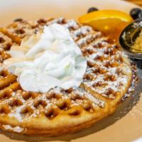 Bubble Waffle · Bubble waffle topped with whipped cream and powdered sugar. Add fruits on top for an additio...