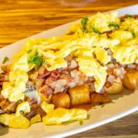 The Meats Skillet · Seasoned potatoes, corned beef, sausage, bacon, ham, queso, and (2) eggs. Served with a whol...