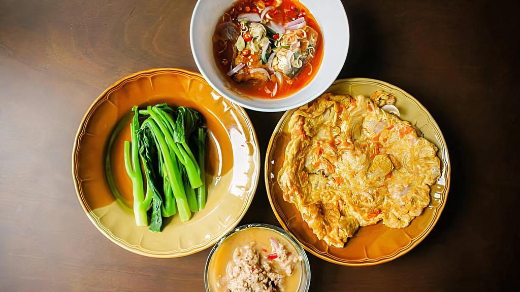 Panang Curry Tofu (R7) · Vegan, gluten free. Medium spiced vegan red coconut curry, sweet potatoes, carrots, Thai basil and black pepper.