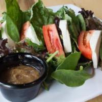 Caprese Salad · Fresh mozzarella, basil, and tomatoes over mixed greens. Comes with balsamic dressing.