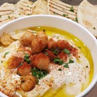 Hummus & Pita · Savory chickpea and tahini dip with toasted pita bread.