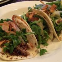 Tacos · Lager brazed pork, avocado crème, pickled peppers and onions, cotija, cilantro, corn tortill...