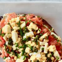 Deluxe Lox Toast · Smoked lox, chive cream cheese, chopped boiled egg, capers and chive. Served with multi grai...