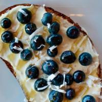 Blueberries & Cream Toast · Vegetarian. Honey whipped cream cheese, blueberries, honey drizzle, coconut flake. Served on...
