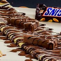 Snickers Crepe · Our summer addition, Snickers crepe stuffed with snickers sauce,  and powder sugar on top of...