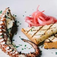 Octopus · freshly charred Spanish octopus, lemon beurre blanc sauce, pickled onions, & grilled focaccia