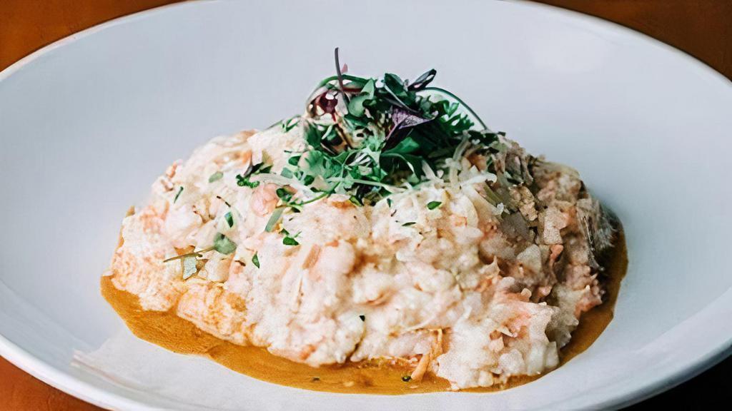 Seafood Risotto · arborio italian rice w/ smoked salmon, prawns, cream, and parmesan on top of our homemade lobster bisque. GF