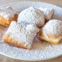 Mini Beignets · Five warm mini beignets served with a dusting of powdered sugar.

Beignets are fried to orde...