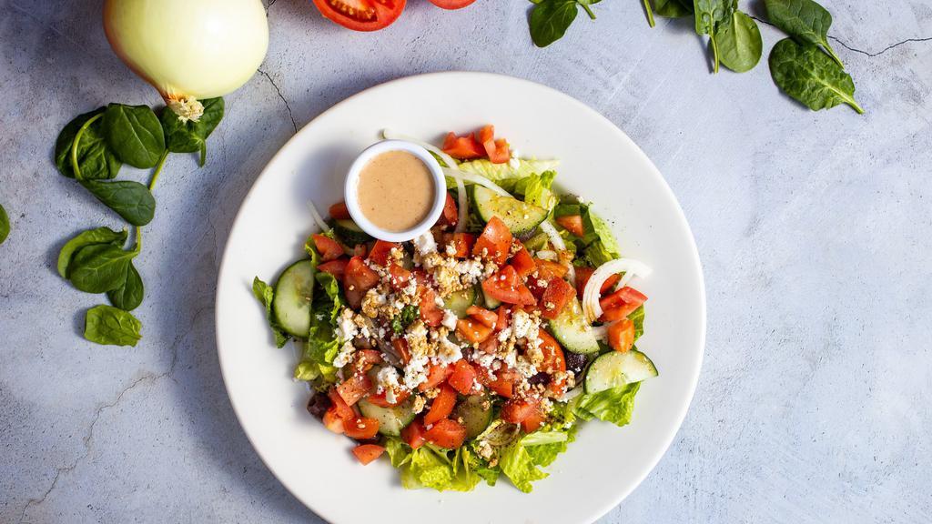 Hide & Greek Salad · Romaine lettuce, cucumbers, tomatoes, red onions, olives, and feta cheese tossed with balsamic vinaigrette dressing.