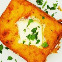 Fried Polenta Cake · Creamy, spicy, polenta cooked in butter with sweet onions and smoked mozzarella, deep fried,...